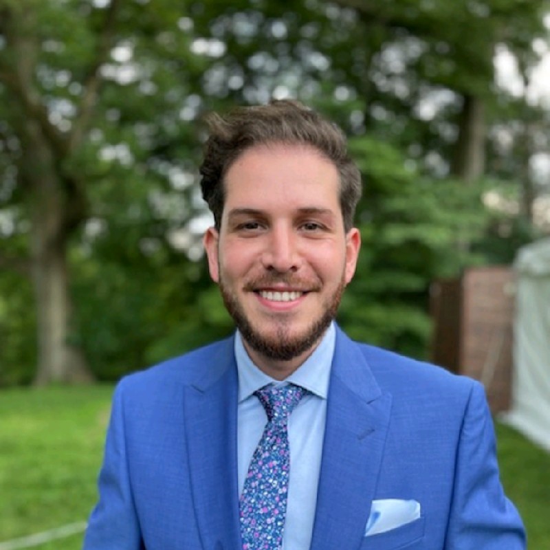 Kevin Harkins smiling in a blue suit